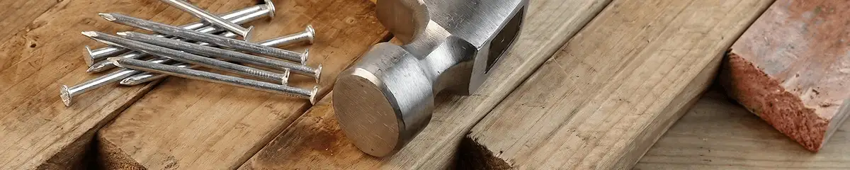 Hammer and nails on hardwood flooring boards in Colorado Springs, CO