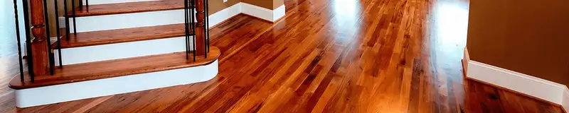 Base floor of a staircase with professionally restored wood flooring in Colorado Springs CO