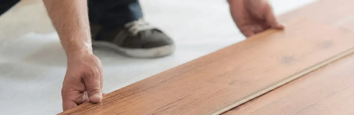 A professional installing laminate flooring in Colorado Springs, CO